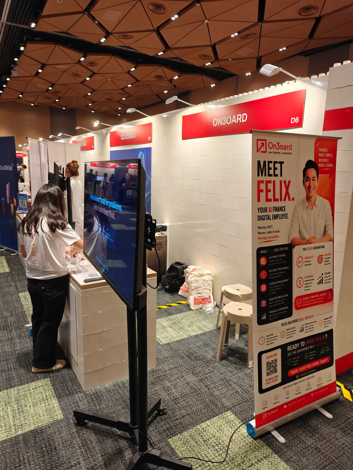 On3oard Booth D6 at Singapore EXPO with a Meet Felix pull-up banner and a demo screen