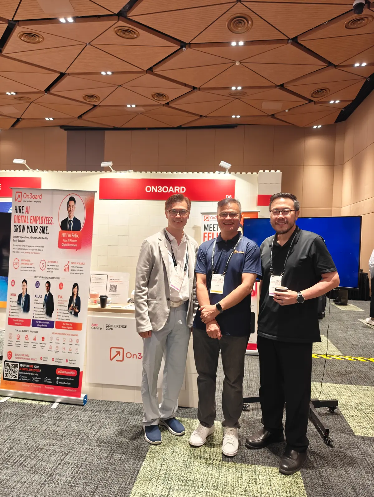 Roy Chin standing between Chin Chee Yung and Hikaru Fujishima of Zenri Advisory in front of the On3oard booth